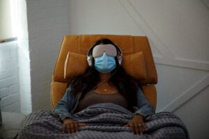 Beatrice Society - A woman with a face mask on a couch undergoing psychedelic therapy