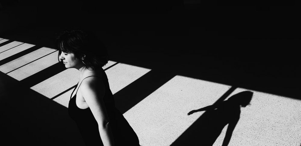 Beatrice Society - a woman in a black dress in a black and white photo